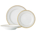 Set of white dinnerware with gold rims on a white background