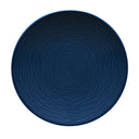 Blue ceramic plate with textured surface on a gray background