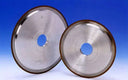 Two metal grinding wheels on a blue background